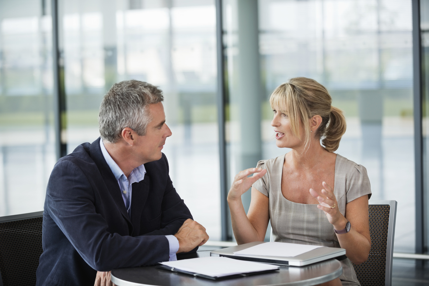 Two business people sitting, having a conversation