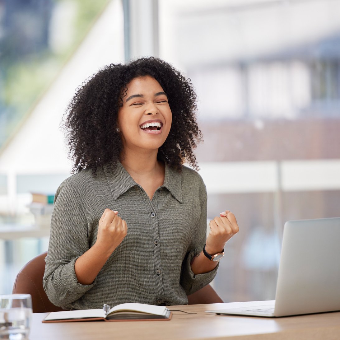 Success, laptop and black woman celebrating in office, happy and excited for bonus target. Good news, email and corporate girl with winning results, achievement or project goal and victory in startup