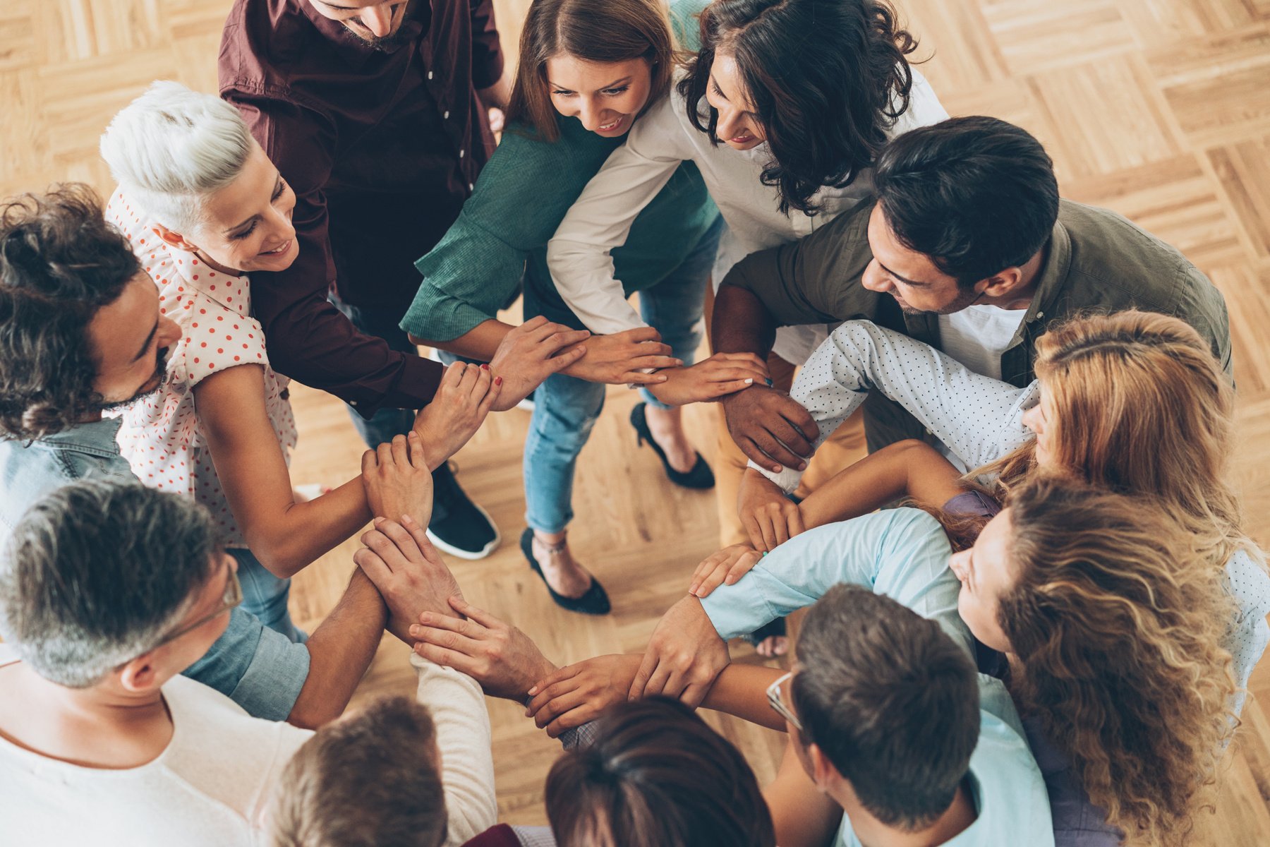 Large group of people connecting hands